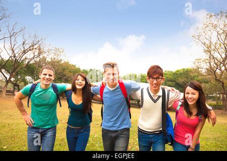 Happy group of students walking together Stock Photo