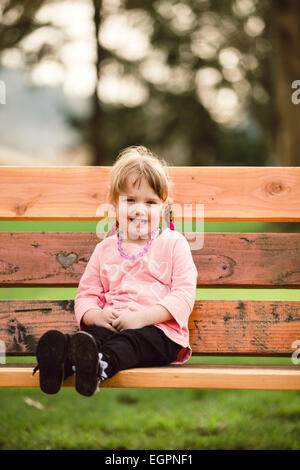 Lifestyle portrait of a young girl at a park with natural light. Stock Photo