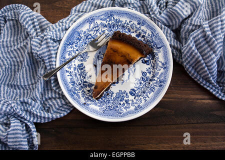 Cake covered in chocolate banana on blue striped tablecloth Stock Photo