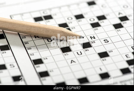 Sharpened Pencil on Top of Crossword Puzzle Game Stock Photo
