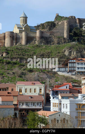 View of St. Nicolas church and Narikala fortress build on hilltop as seen from Abanotubani district in the the Kala old part of Tbilisi the capital of Republic of Georgia Stock Photo