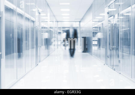 businessman goes along a corridor at modern office Stock Photo