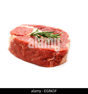 Raw ribeye steak garnished with sprig of rosemary, isolated Stock Photo