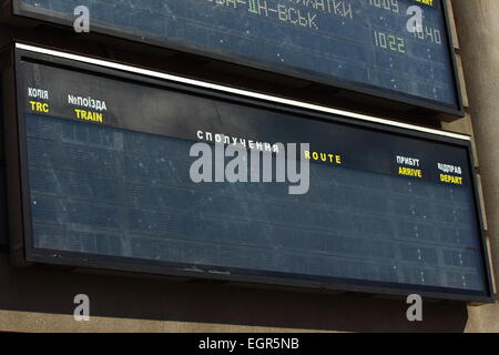 Information sign, showing a timetable for trains, at a central station ...