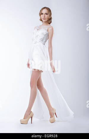 Slender Fashion Model Wearing White Dress Stock Photo