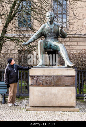 Berlin public art - senior man with statue, sculpture of Poet, Heinrich Heine monument  - by sculptor, Waldemar Grzimek Stock Photo