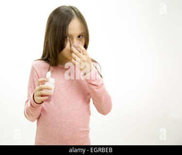 Young girl pouring and taking medicine Stock Photo