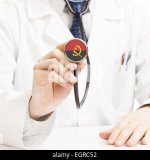 Doctor holding stethoscope with flag series - Angola Stock Photo