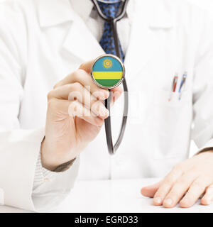 Doctor holding stethoscope with flag series - Rwanda Stock Photo