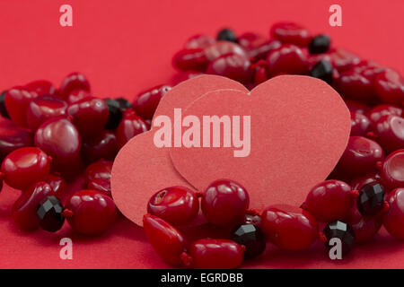 heart, coral necklace on a red background Stock Photo