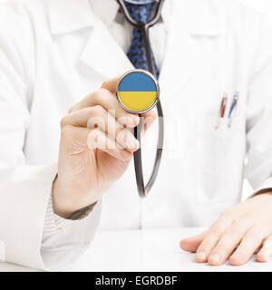 Doctor holding stethoscope with flag series - Ukraine Stock Photo