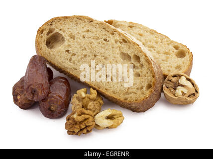 still life sliced ​​bread, dates and nuts on a white background Stock Photo
