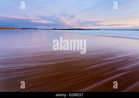 Streaky patterns created by retreating waves on the sandy shores of Tyninghame beach. Stock Photo
