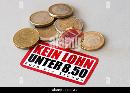 Dresden, Germany. 26th Feb, 2015. ILLUSTRATION - Euro coins, worth 8, 50 euro, and a sticker, issued by the Confederation of German Trade Unions (DGB), which reads 'No wages below 8, 50 euro per hour', are on display in Dresden, Germany, 26 February 2015. Photo: Arno Burgi/dpa/Alamy Live News Stock Photo