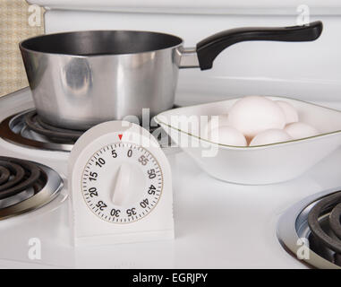 Kitchen tools for boiling eggs on stove Stock Photo