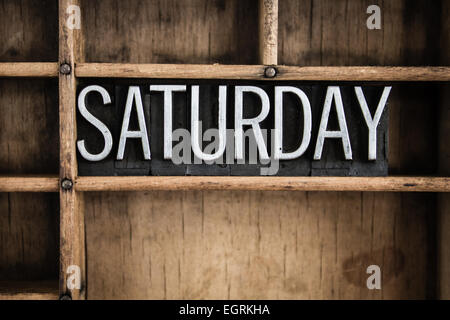 The word 'SATURDAY' written in vintage metal letterpress type in a wooden drawer with dividers. Stock Photo