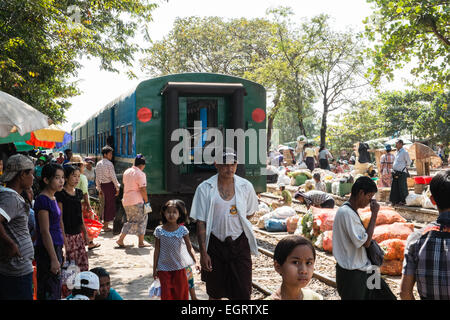 At fruit and vegetable market next to  train tracks, 3 hour circle train ride through Yangon and suburbs Yangon,Rangoon,Myanmar, Stock Photo