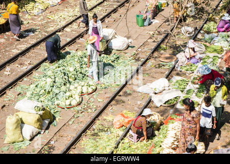 At fruit and vegetable market next to  train tracks, 3 hour circle train ride through Yangon and suburbs Yangon,Rangoon,Myanmar, Stock Photo