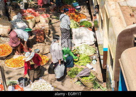 At fruit and vegetable market next to  train tracks, 3 hour circle train ride through Yangon and suburbs Yangon,Rangoon,Myanmar, Stock Photo