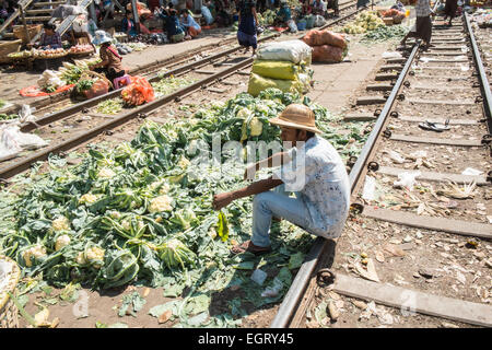 At fruit and vegetable market next to  train tracks, 3 hour circle train ride through Yangon and suburbs Yangon,Rangoon,Myanmar, Stock Photo