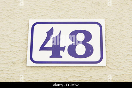 Number forty-eight in the wall of a house, the number of information, even number Stock Photo