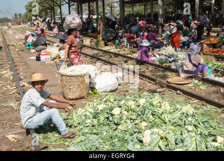 At fruit and vegetable market next to  train tracks, 3 hour circle train ride through Yangon and suburbs Yangon,Rangoon,Myanmar, Stock Photo