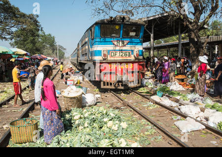 At fruit and vegetable market next to  train tracks, 3 hour circle train ride through Yangon and suburbs Yangon,Rangoon,Myanmar, Stock Photo