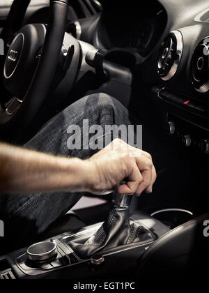 License available at MaximImages.com - Closeup of a man driving a car with his hand on a gear shift lever Stock Photo