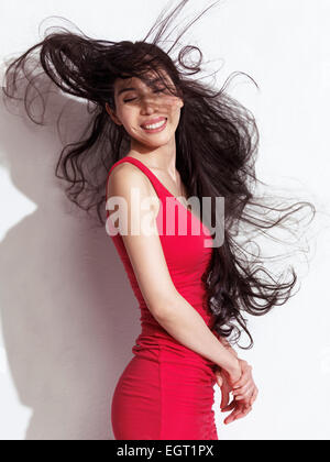 https://l450v.alamy.com/450v/egt1px/smiling-japanese-woman-in-red-dress-with-waist-long-flying-black-hair-egt1px.jpg