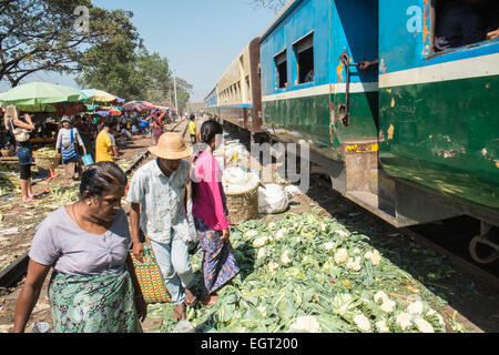 At fruit and vegetable market next to  train tracks, 3 hour circle train ride through Yangon and suburbs Yangon,Rangoon,Myanmar, Stock Photo