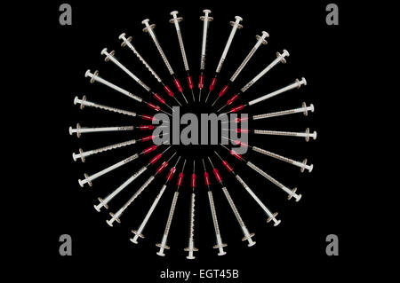 Used syringes arranged in a circle; concept shot for drug abuse Stock Photo