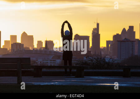 Primrose Hill, London, UK. 2nd March, 2015. As forecasters are beginning to predict the coming of spring, the sun rises over London as dog walkers and runners exercise on Primrose Hill as the sun rises on a chilly London morning. Credit:  Paul Davey/Alamy Live News
