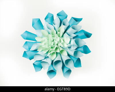 abstract image of origami flower shape made out of rolled sheets of paper on white background Stock Photo