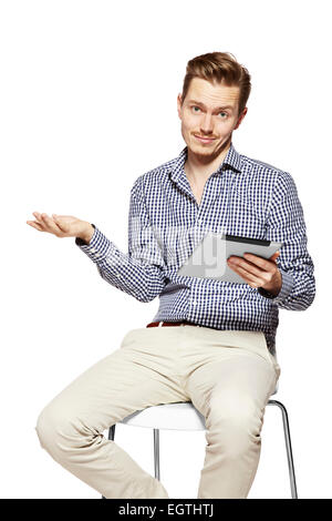 Disappointed young man holding tablet. Studio shot isolated on white. Stock Photo