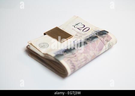 A pile of used UK Sterling Cash £20 and £10 notes Stock Photo