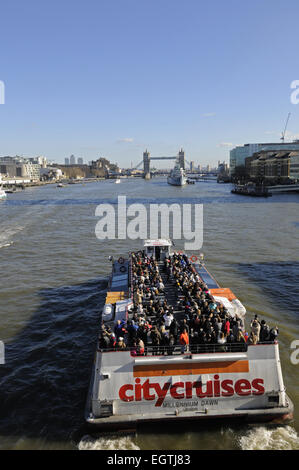 The view from London Bridge along the River Thames with Riverboat to the HMS Belfast and Tower Bridge London England Stock Photo