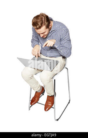 Young man leaning over the keyboard. Isolated on white background. Stock Photo