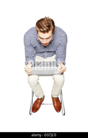 Young man leaning over the keyboard. Stock Photo