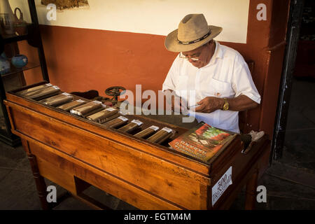 Man rolling and selling cigars at the La Canchanchara bar in Trinidad, Cuba. Stock Photo