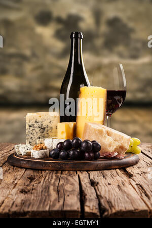 Various kind of cheese with red wine in cellar Stock Photo