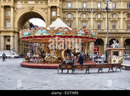 A fairground merry-go-round, roundabout or carousel in the Piazza della Repubblica in the centre of Florence, Italy Stock Photo