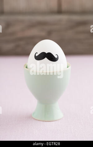 Easter egg with moustache in egg cup Stock Photo