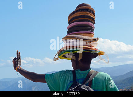 Senegalese beach trader in Sardinia Stock Photo