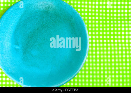 closeup to blue plate on green  checkered tablecloth Stock Photo