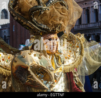 Golden mask with decorations and carvings during the Carnival of Venice 2015 edition. Stock Photo