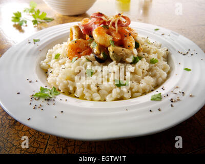 Classic risotto with prawns, mussels and bacon Stock Photo