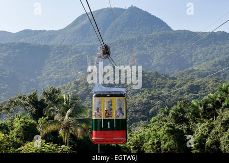 Tourists in Teleforico cable car above rainforest trees on Pico Isabel de Torres mountain Puerto Plata Dominican Republic Stock Photo