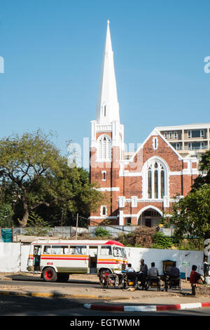 Colourful local Hino bus truck parked in centre of  Yangon,Rangoon, Burma,Myanmar, in front of a Catholic church. Stock Photo