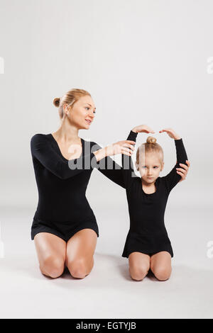 Mom teaching daughter gymnastics. Stock Photo