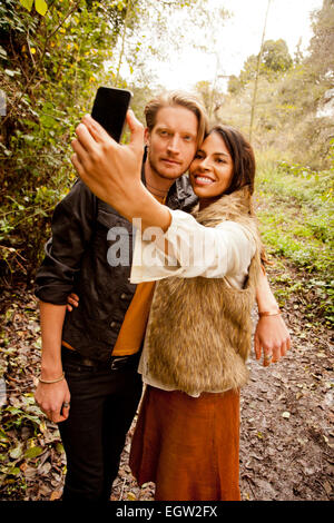 Woman and man taking a selfie in the woods. Stock Photo